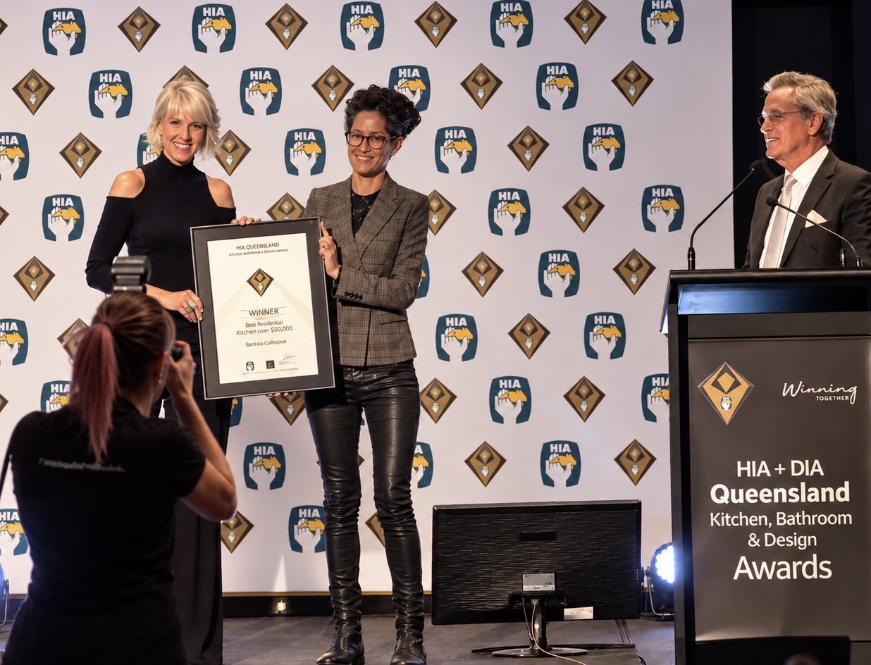 Ros Banksia-Smith on stage as Banksia Collective is presented the HIA Queensland award certificate for Best Residential Kitchen over $50,000